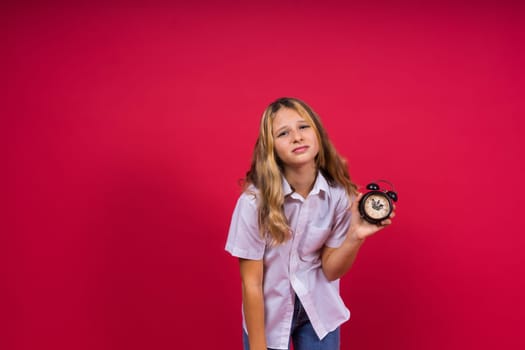 Young Girl holding antique clock over red background