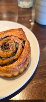 delicious freshly baked Cinnamon rolls or cinnamon bun, with raisins and vanilla also icing sugar ridiculously good pastry