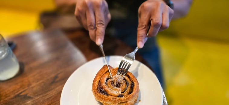 delicious freshly baked Cinnamon rolls or cinnamon bun, with raisins and vanilla also icing sugar ridiculously good pastry