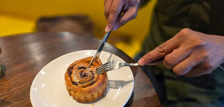 delicious freshly baked Cinnamon rolls or cinnamon bun, with raisins and vanilla also icing sugar ridiculously good pastry