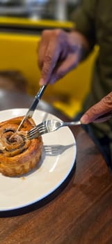 delicious freshly baked Cinnamon rolls or cinnamon bun, with raisins and vanilla also icing sugar ridiculously good pastry