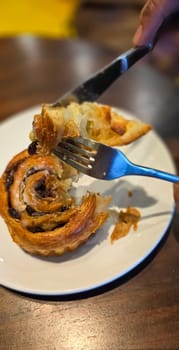 delicious freshly baked Cinnamon rolls or cinnamon bun, with raisins and vanilla also icing sugar ridiculously good pastry