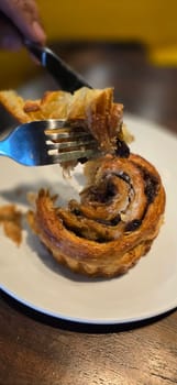 delicious freshly baked Cinnamon rolls or cinnamon bun, with raisins and vanilla also icing sugar ridiculously good pastry