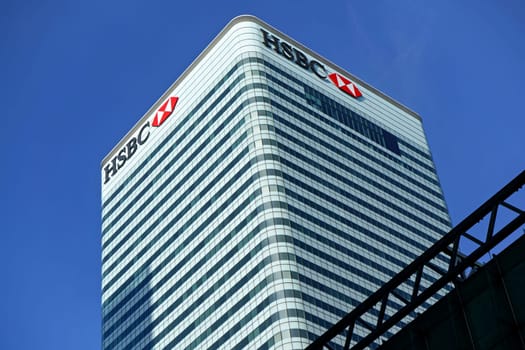 London, United Kingdom - February 03, 2019: Sun shines on world Headquarters of HSBC Holdings plc at 8 Canada Square, Canary Wharf. It is 7th largest bank worldwide, was established in 1865