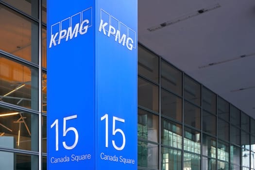 London, United Kingdom - February 03, 2019: Blue KPMG signage at entrance to their offices on 15 Canada Square in Canary Wharf - headquarters of company in the UK. It's one of big 4 accounting firms