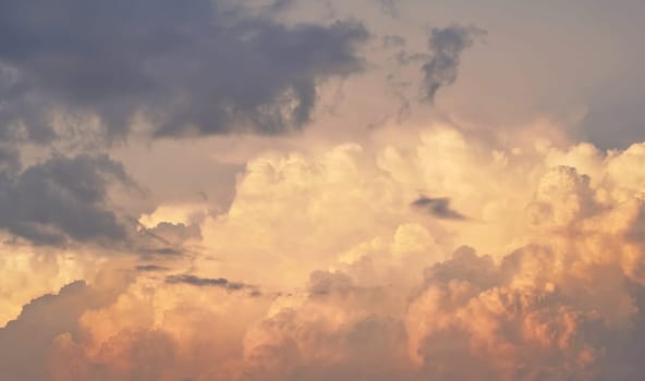 Orange clouds on evening sky during sunset