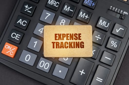 Financial concept. There is a sign on the calculator that says - Expense tracking