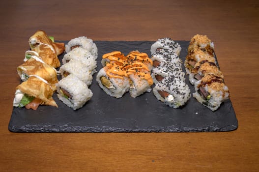 Futomaki, hosomaki and nigiris - japanese rolls closeup. High quality photo,