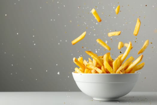 A white bowl filled with golden french fries placed on top of a wooden table.