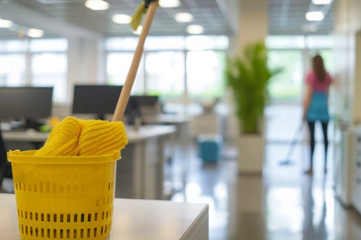 A yellow basket containing a mop and a yellow mop, part of the cleaning supplies used by Vladimka Cleaning Service in an office setting.