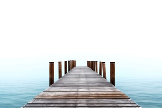A tranquil wooden pier extends into serene blue waters under a clear sky, evoking peace and simplicity.