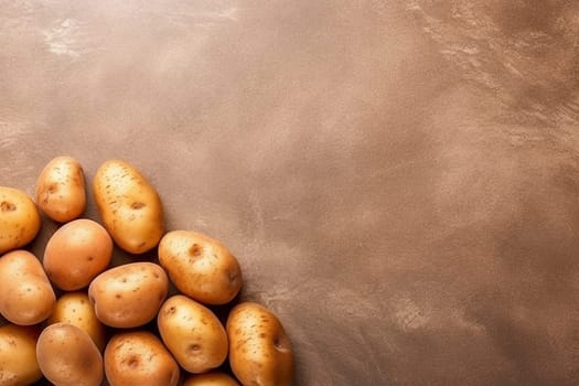 A pile of fresh potatoes on a brown surface.