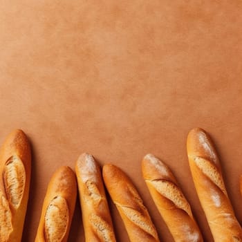 Assorted baguettes on a brown background, viewed from above.