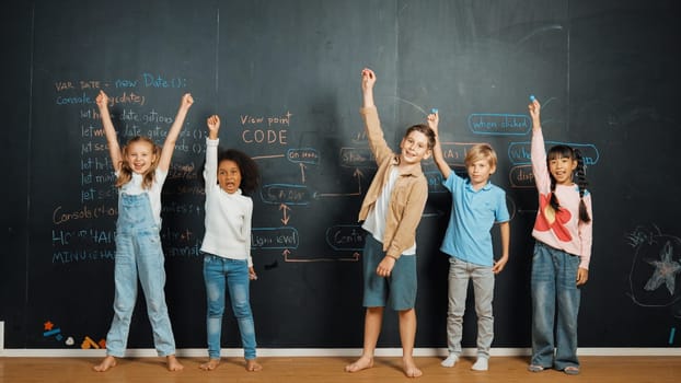 Diverse student raised hands up while standing at blackboard written with engineering prompt or coding, programing system code. Showing comment, asking questions, volunteering, voting. Erudition.