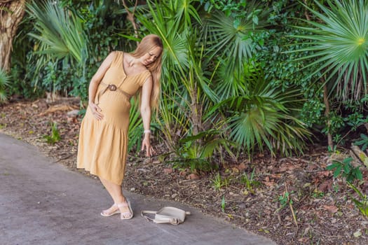 pregnant woman drops her keys and struggles to pick them up, highlighting the physical limitations that can arise during pregnancy. Patience and support become essential.