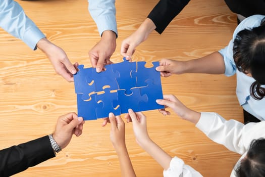 Top view multiethnic business people holding jigsaw pieces and merge them together as effective solution solving teamwork, shared vision and common goal combining diverse talent. Habiliment