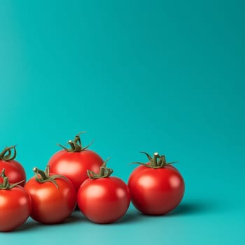 Fresh red tomatoes on turquoise background.