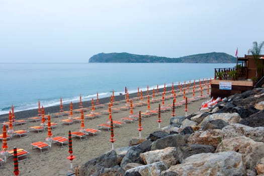 Seaside lido with closed umbrellas on Palinuro beach to indicate a tourism concept. High quality photo