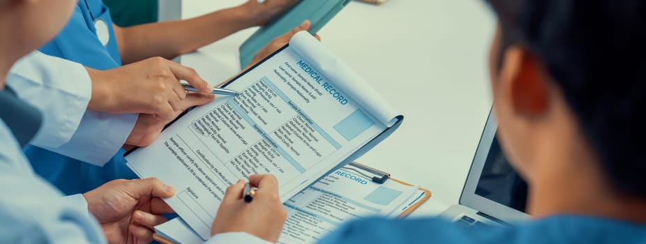 Professional various team of medical working and planning medical treatment at hospital table together. Teamwork lead to successful illness and sickness treatment. Panorama Rigid