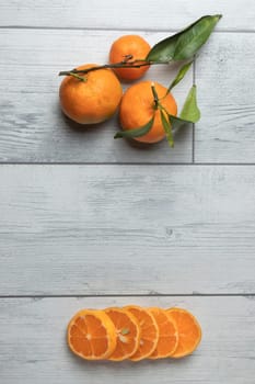 A composition of mandarins on a white background. Mandarin slices. Mandarin with leaves