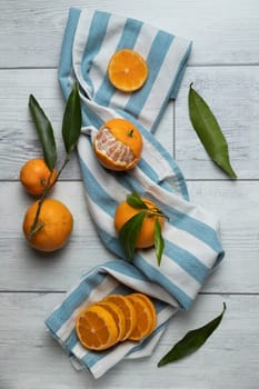 A composition of mandarins on a white background. Mandarin slices. Mandarin with leaves