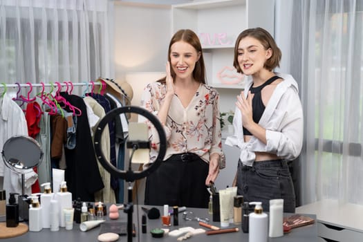 Woman influencer shoot live streaming vlog video review makeup utmost social media or blog. Happy young girl with cosmetics studio lighting for marketing recording session broadcasting online.