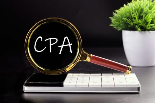 CPA, Certified Public Accountant or Cost per Action text seen with a magnifying glass on a black background