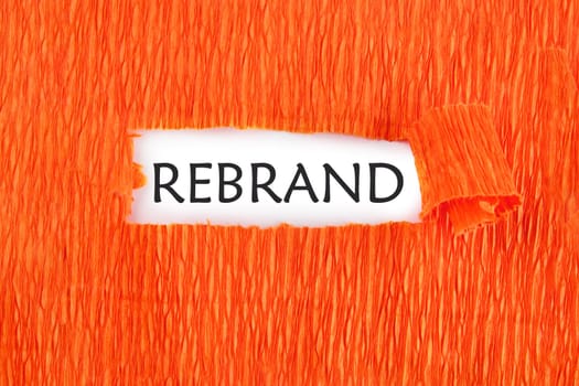REBRAND the text under the torn paper is orange on a white background