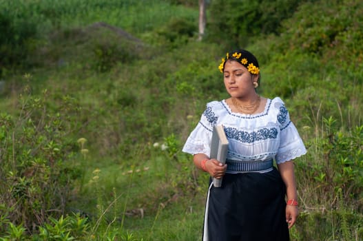 A woman wearing a blue dress stands confidently in a vibrant field in Ecuador.