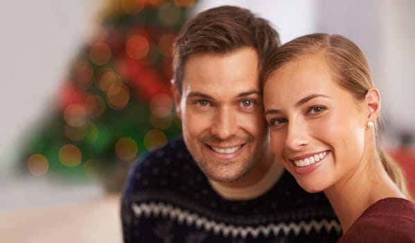 Portrait, Christmas and couple with holiday, hug and party with romance and home with lights. Face, apartment and man with woman and celebration with embrace and festive season with marriage and Xmas.