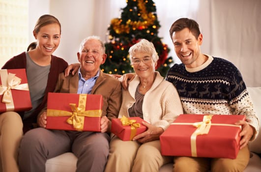 Grandparents, family with Christmas or portrait for festive season together for celebration, presents or holiday. Elderly man, woman and couch at home in Canada for bonding joy, vacation or relaxing.
