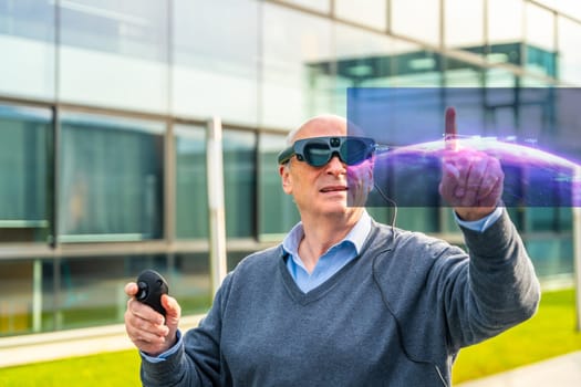 Aged man wearing mixed augmented goggles interacting with virtual computer graphics outdoors