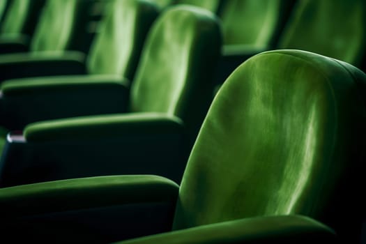 Empty green seats in cinema, domestic intimacy, zoom in, up close. Neural network generated in January 2024. Not based on any actual scene or pattern.