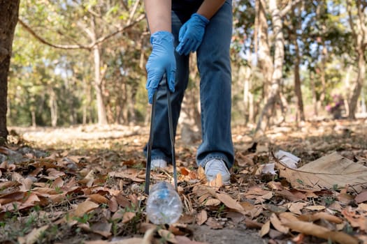 Young people friend volunteer collecting garbage plastic bottles to trash bags. environmental care ecology concept.