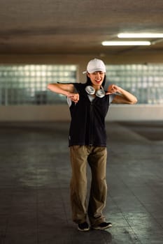 Smiling young female dancing in parking garage. Hobby and active lifestyle concept.
