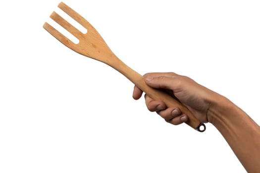 Hand holding wooden fork on white background cutout. High quality photo