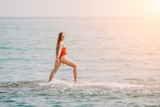 Woman sea yoga. Back view of free calm happy satisfied woman with long hair standing on top rock with yoga position against of sky by the sea. Healthy lifestyle outdoors in nature, fitness concept.