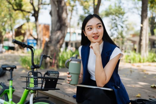 Professional Business woman with bike in the morning walking in the street to work. Eco friendly.