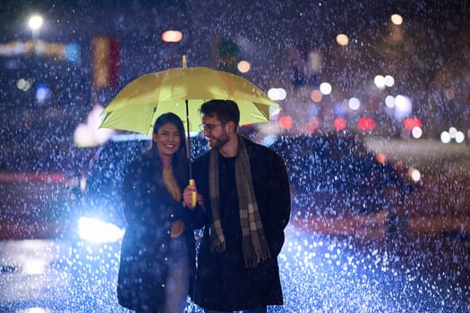 In the romantic ambiance of a rainy night, a happy couple walks through the city, sharing tender moments under a yellow umbrella, surrounded by the glistening glow of urban lights.