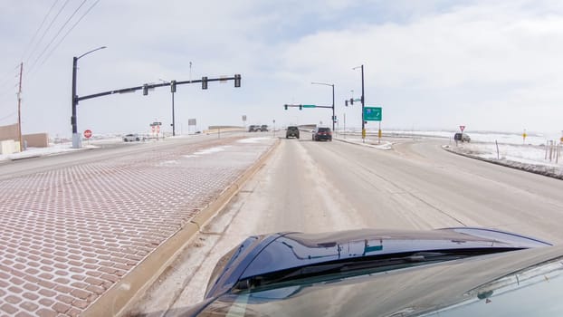 Castle Pines, Colorado, USA-January 30, 2023-Post-winter storm, the drive on a suburban road provides a peaceful journey. The picturesque scene, with snow adorning the landscape, adds to the tranquility of the experience.