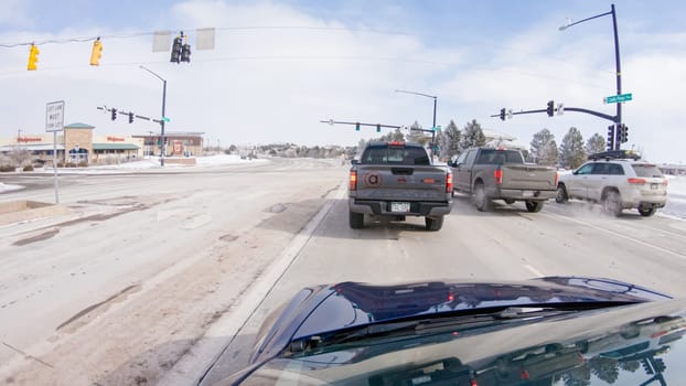 Castle Pines, Colorado, USA-January 30, 2023-Post-winter storm, the drive on a suburban road provides a peaceful journey. The picturesque scene, with snow adorning the landscape, adds to the tranquility of the experience.