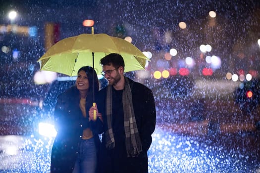 In the romantic ambiance of a rainy night, a happy couple walks through the city, sharing tender moments under a yellow umbrella, surrounded by the glistening glow of urban lights.