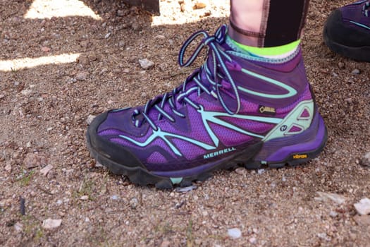 Purple merrel Women's hiking boot close up background . High quality photo