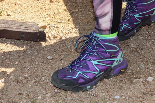 Purple merrel Women's hiking boot close up background . High quality photo