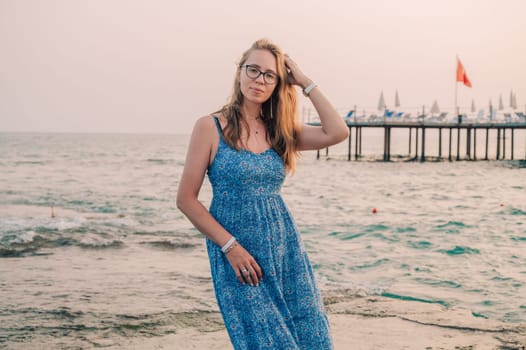 Woman sits on the beach and looks at the sea in Alanya city, Turkey. Travelling or vacation concept