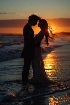 A bride and groom sharing a romantic kiss on the beach as the sun sets in the background.