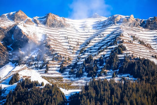 Avalanche protection fence on Alpine peak above Wengen view, Alps in Switzerland