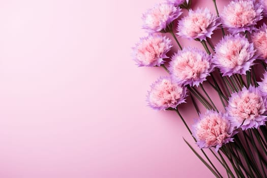 Pink horizontal background with a bouquet of lilac flowers.