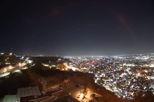 Fisheye wide shot of cityscape lights stretching off into the distance view from mehrangarh fort of Jodhpur city Indiag