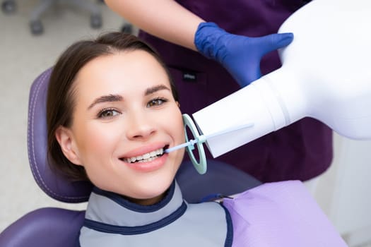 Happy patient during X ray of teeth at the dental clinic.